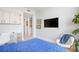Modern bedroom features a plush blue bed, TV, and accent chair, offering a cozy and stylish retreat at 301 1St Street S # 1901, St Petersburg, FL 33701