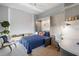 Comfortable bedroom with a sofa, desk, and built-ins, complemented by a bright window and stylish decor at 301 1St Street S # 1901, St Petersburg, FL 33701