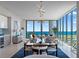 Bright dining room with modern lighting, dining table, and a scenic ocean view from the adjacent windows and sliding door at 301 1St Street S # 1901, St Petersburg, FL 33701