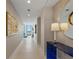 Modern condo hallway features neutral walls, tile floors, and stunning city views through the windows at the end at 301 1St Street S # 1901, St Petersburg, FL 33701