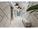 Hallway with modern elevators, unique geometric wall paneling, and stylish lighting offering a blend of function and design at 301 1St Street S # 1901, St Petersburg, FL 33701