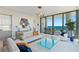 Stylish living room with modern furnishings, an open layout, and access to a balcony with scenic ocean views at 301 1St Street S # 1901, St Petersburg, FL 33701