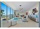 Elegant living room with floor-to-ceiling windows showcasing stunning city views, open to a modern gourmet kitchen at 301 1St Street S # 1901, St Petersburg, FL 33701
