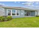 Home featuring blue siding, spacious backyard, and well-maintained lawn at 31430 Hayman Loop, Wesley Chapel, FL 33545
