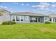 Home featuring blue siding and spacious backyard with lawn at 31430 Hayman Loop, Wesley Chapel, FL 33545
