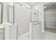 Bright bathroom featuring a glass enclosed shower with tiled walls and a walk-in closet at 31430 Hayman Loop, Wesley Chapel, FL 33545