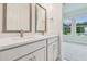 Bathroom featuring a double sink vanity and backyard views at 31430 Hayman Loop, Wesley Chapel, FL 33545