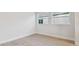 Clean, bright bedroom with wood-look floors and natural light from two windows at 31430 Hayman Loop, Wesley Chapel, FL 33545