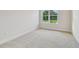 Bedroom featuring plush carpet and a large window with a view of the outdoors at 31430 Hayman Loop, Wesley Chapel, FL 33545