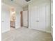 Carpeted bedroom featuring closet and entry to the bathroom at 31430 Hayman Loop, Wesley Chapel, FL 33545