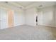 Spacious bedroom with neutral carpet and two entryways, one to closet, one to hallway at 31430 Hayman Loop, Wesley Chapel, FL 33545