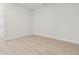 Clean bedroom with wood-look flooring and bright white trim at 31430 Hayman Loop, Wesley Chapel, FL 33545