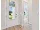 Entryway featuring wood-look flooring, a glass door, and neutral colors at 31430 Hayman Loop, Wesley Chapel, FL 33545