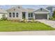 Charming home featuring a lush green lawn and tastefully arranged plants at 31430 Hayman Loop, Wesley Chapel, FL 33545