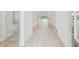 Inviting hallway with wood floors leading to other rooms in the home at 31430 Hayman Loop, Wesley Chapel, FL 33545