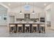 Bright, modern kitchen with stainless steel appliances, large island, and pendant lighting at 31430 Hayman Loop, Wesley Chapel, FL 33545