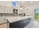 Bright kitchen featuring a spacious island, stainless steel appliances, and modern cabinetry at 31430 Hayman Loop, Wesley Chapel, FL 33545