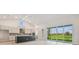 Modern kitchen featuring an island, stainless appliances, and seamless indoor-outdoor living at 31430 Hayman Loop, Wesley Chapel, FL 33545