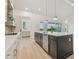 Open kitchen featuring a large island with counter seating and lots of natural light at 31430 Hayman Loop, Wesley Chapel, FL 33545