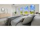 Bright main bedroom featuring multiple windows overlooking green space at 31430 Hayman Loop, Wesley Chapel, FL 33545
