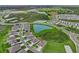 Aerial view of the community featuring well-maintained homes, green spaces, and a serene lake, showcasing the community layout at 3528 Golden Wheat Ln, Plant City, FL 33565