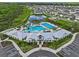 Aerial view of community pool and clubhouse surrounded by lush landscaping at 3528 Golden Wheat Ln, Plant City, FL 33565
