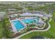 Breathtaking aerial view of the community featuring lush landscaping, pool, clubhouse, playground, and well-maintained grounds at 3528 Golden Wheat Ln, Plant City, FL 33565