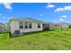 Well maintained backyard with healthy green grass, and a view of the screened in patio at 3528 Golden Wheat Ln, Plant City, FL 33565