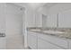 Bathroom featuring a double vanity with granite countertop and access to Primary bedroom at 3528 Golden Wheat Ln, Plant City, FL 33565
