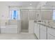 Bathroom showcasing soaking tub, shower with glass door, and vanity with granite countertop at 3528 Golden Wheat Ln, Plant City, FL 33565