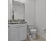 Neutral-toned half bath featuring granite countertop and white vanity with cabinet storage at 3528 Golden Wheat Ln, Plant City, FL 33565