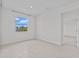 Bedroom featuring neutral walls, tile flooring, and a bright window at 3528 Golden Wheat Ln, Plant City, FL 33565