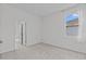 Neutral bedroom with plush carpet, a window, and a closet door at 3528 Golden Wheat Ln, Plant City, FL 33565