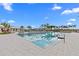 Large community pool with clear blue water and surrounding lounge area with tables and chairs for residents to relax at 3528 Golden Wheat Ln, Plant City, FL 33565