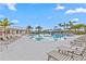 Beautiful community pool area featuring lounge chairs, palm trees, and a thrilling slide for residents to enjoy at 3528 Golden Wheat Ln, Plant City, FL 33565