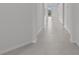 Hallway with tile floors, white walls, and baseboards at 3528 Golden Wheat Ln, Plant City, FL 33565