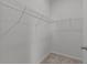 Walk-in closet with white wire shelving and neutral carpeted floor at 3528 Golden Wheat Ln, Plant City, FL 33565