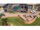 Aerial view of backyard featuring a pool, screened-in patio, and fire pit area at 3668 Janus Way, Palm Harbor, FL 34685