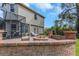 Backyard with a brick fire pit and outdoor seating at 3668 Janus Way, Palm Harbor, FL 34685