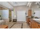 Spacious primary bathroom with glass block shower, soaking tub, dual sinks, and tile flooring for a serene spa-like retreat at 3668 Janus Way, Palm Harbor, FL 34685