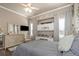 Bright bedroom featuring a TV, built in desk, and light colored furniture, offering a cozy and functional space at 3668 Janus Way, Palm Harbor, FL 34685