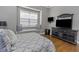 Cozy bedroom features a window seat, a decorative dresser and smooth hardwood flooring at 3668 Janus Way, Palm Harbor, FL 34685