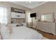 Calming primary bedroom with built-in desk, dresser, and hardwood floors, creating a relaxing and functional space at 3668 Janus Way, Palm Harbor, FL 34685