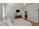 Bedroom with hardwood floors, a ceiling fan, and a view into the game room at 3668 Janus Way, Palm Harbor, FL 34685