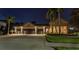 Stunning home exterior at night, featuring a long drive and three-car garage at 3668 Janus Way, Palm Harbor, FL 34685