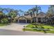 Charming home showcasing a three-car garage, and meticulously manicured landscaping at 3668 Janus Way, Palm Harbor, FL 34685