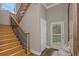 Foyer featuring wood staircase with iron spindles and a door to the backyard at 3668 Janus Way, Palm Harbor, FL 34685