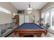 Spacious game room with a billiard table, couch, and fitness equipment at 3668 Janus Way, Palm Harbor, FL 34685