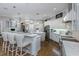 Open concept kitchen with bar seating, stainless appliances, and hardwood flooring at 3668 Janus Way, Palm Harbor, FL 34685