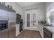 Modern kitchen with stainless steel appliances, mosaic backsplash, and access to the outdoors at 3668 Janus Way, Palm Harbor, FL 34685